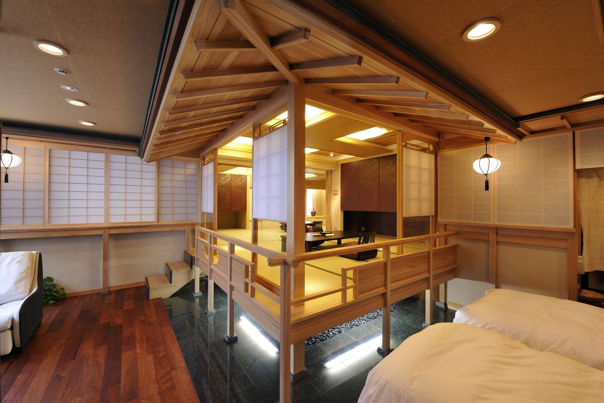 A traditional Japanese-style room with tatami flooring, a low wooden table, and a sliding door.