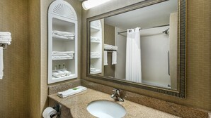 A bathroom with a sink, mirror, towel rack, and shower curtain. - Holiday Inn Express Hotel & Suites Tilton - Lakes Region by IHG (Tilton)