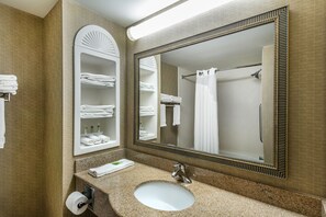 A bathroom with a sink, mirror, towel rack, and shower curtain. - Holiday Inn Express Hotel & Suites Tilton - Lakes Region by IHG (Tilton)
