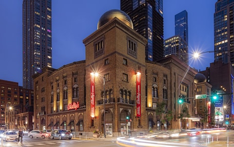 A historic building with a prominent casino sign, surrounded by modern skyscrapers.