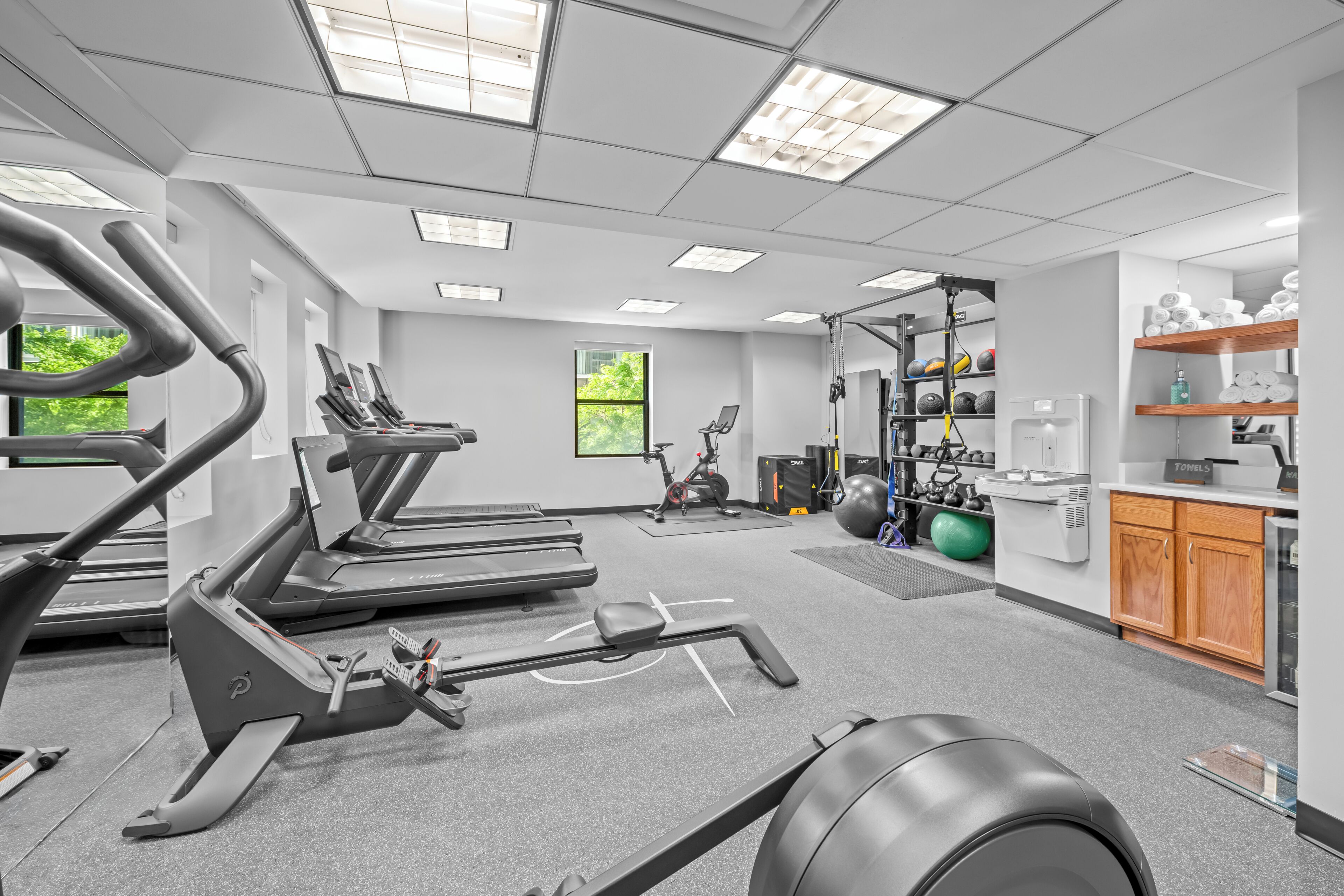 A gym with treadmills, exercise balls, and weightlifting equipment.