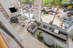A modern interior with a seating area, tables, and a fireplace.