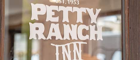 A window with the text "PETTY RANCH INN EST. 1953".