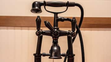 A bathroom with a vintage-style faucet and a copper sink.