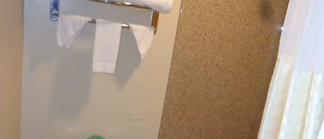 A bathroom with a toilet, a bathtub, and a shower.