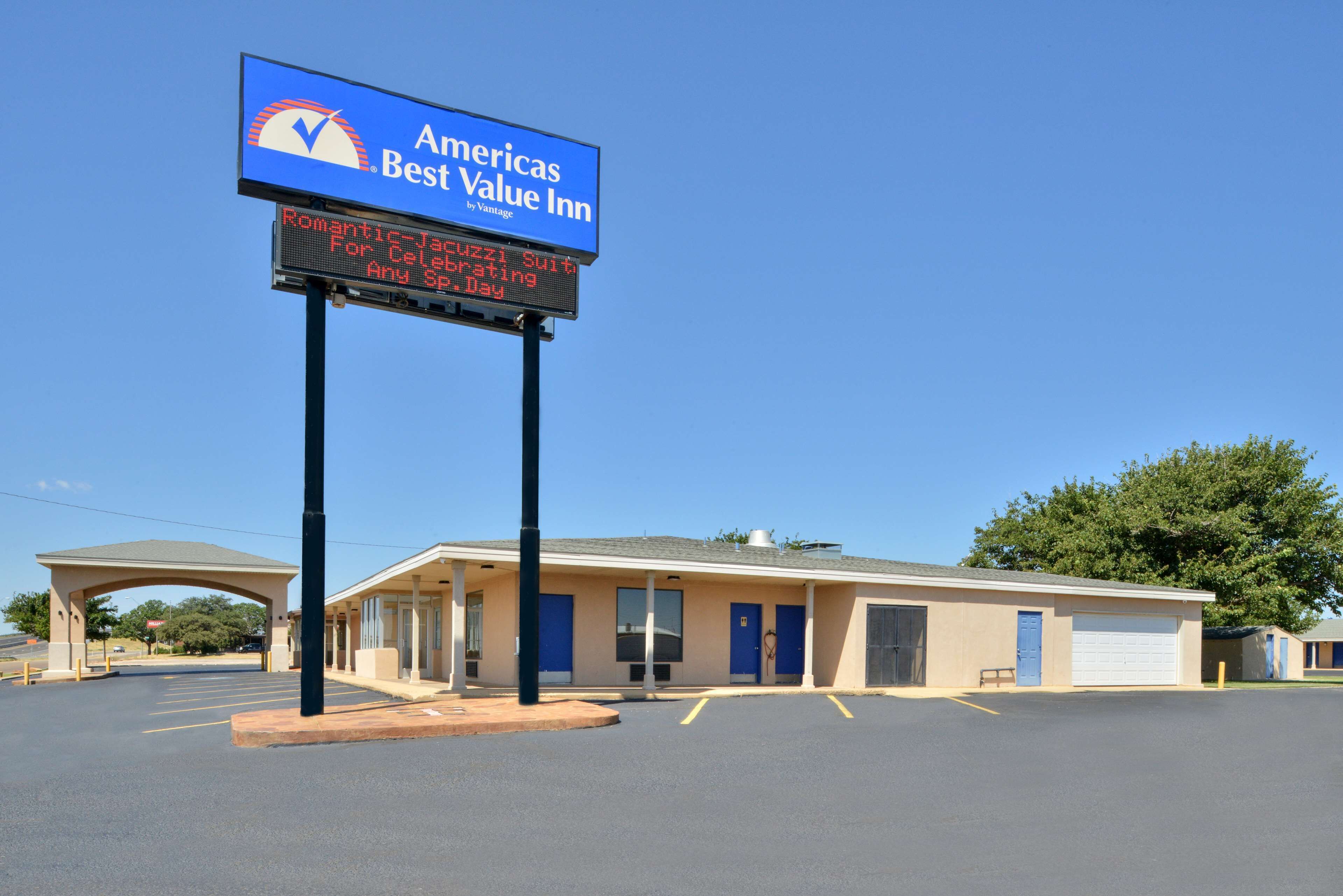 A motel with a sign advertising a romantic Jacuzzi suit for celebrations.