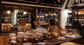 A breakfast buffet with various food items and a bar area with bottles. - Tralala Hotel Montreux (Montreux)