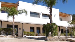 A modern two-story building with a flat roof, large windows, and a white facade. - Natur Hotel Tanca (Cardedu)