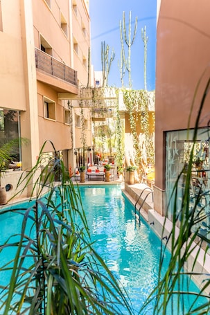 Outdoor pool, sun loungers. Dellarosa Boutique Hotel & Spa
