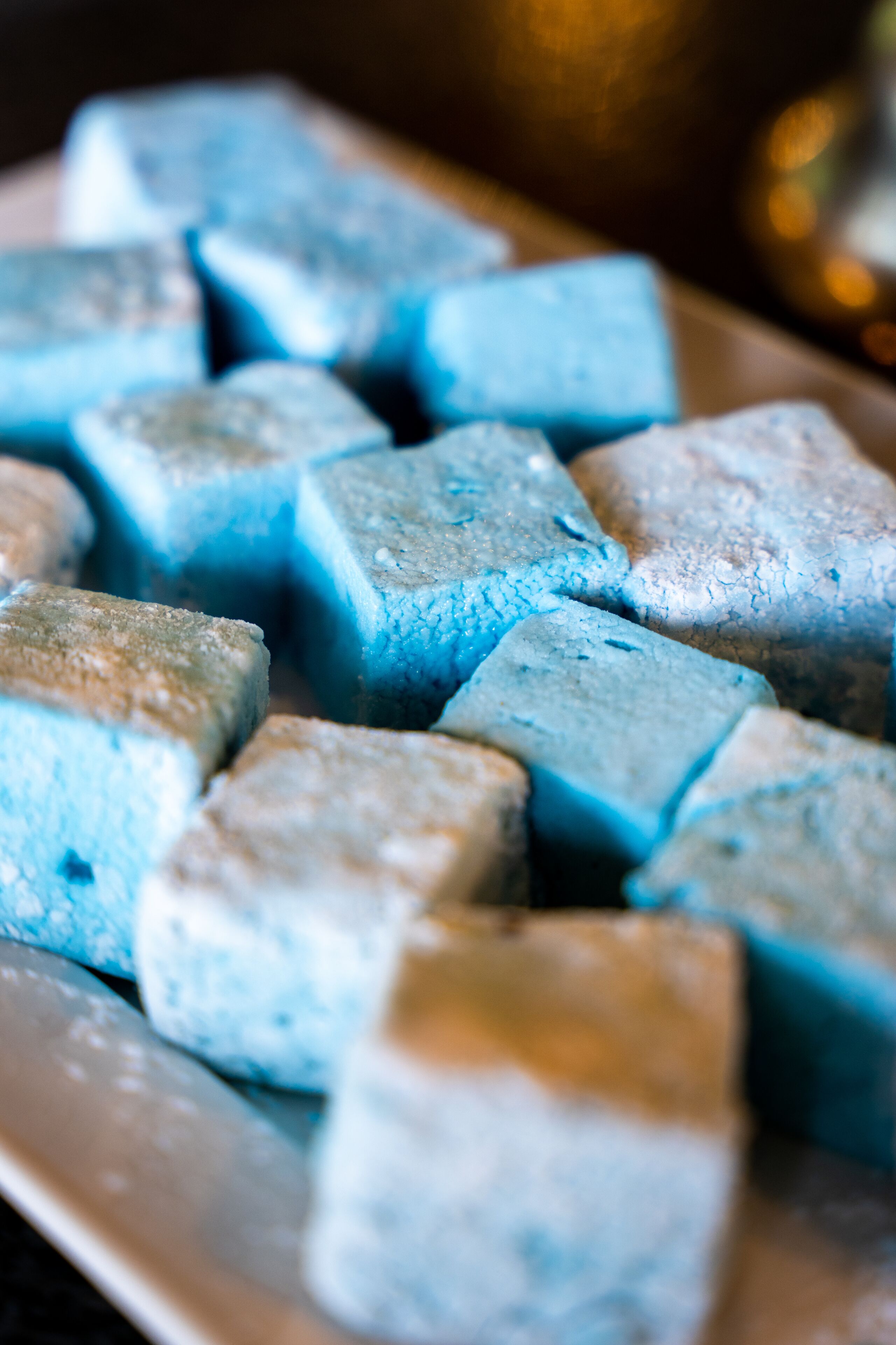 A plate of blue-colored food items.