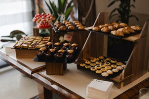 A buffet table with various pastries and desserts.
