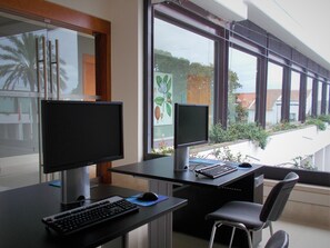 A modern office space with two computer monitors, a keyboard, and a mouse on a desk.
