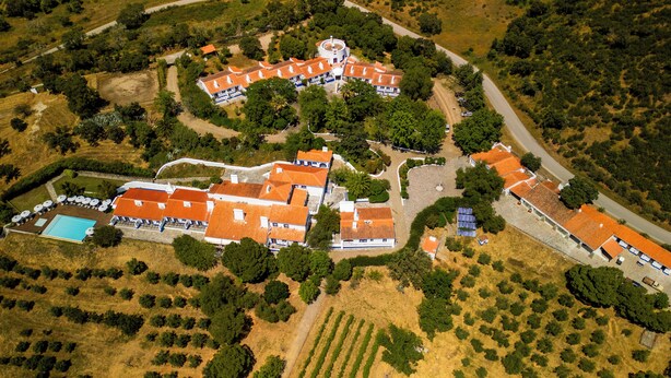 An aerial view of a resort with multiple buildings, a swimming pool, and surrounding greenery. - Horta da Moura by WOT Signature (Reguengos de Monsaraz)