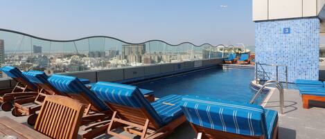 Outdoor pool, open 8:30 AM to 7:00 PM, pool loungers