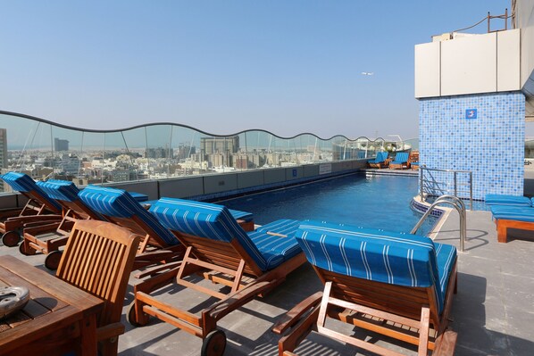 Outdoor pool, open 8:30 AM to 7:00 PM, pool loungers