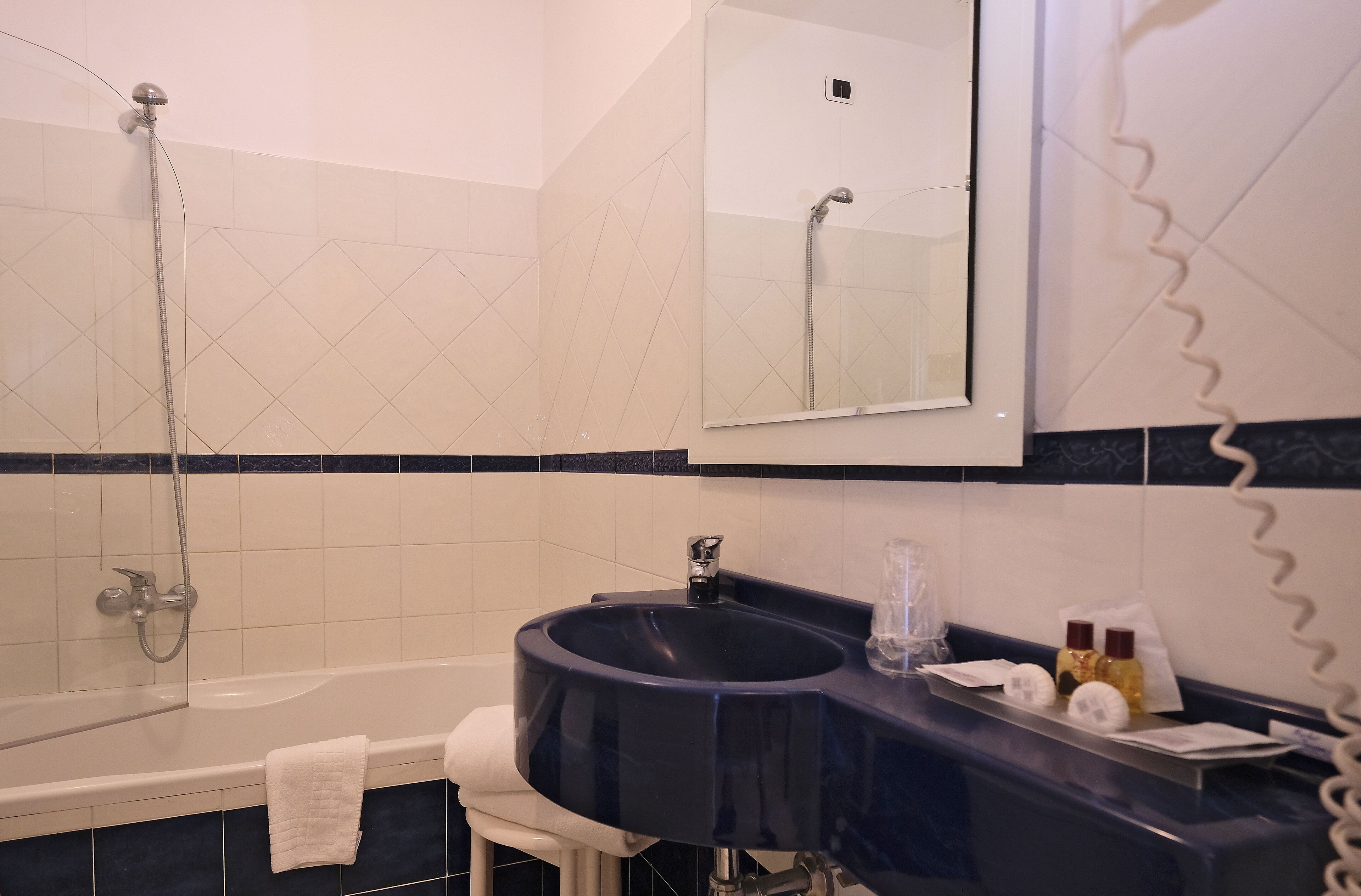 A bathroom with a bathtub, a sink, and a shower.
