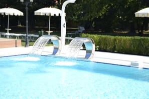 Seasonal outdoor pool, open 9:00 AM to 7:00 PM, pool umbrellas