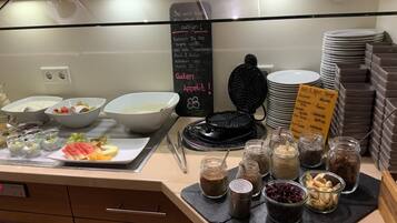 A buffet area with various food items and condiments.