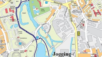 Une carte détaillée d’un quartier de la ville, indiquant l’emplacement d’un hôtel, des pistes de course à pied et de sentiers pédestres, ainsi qu’un parc sportif.