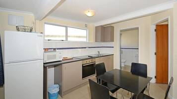 Full-size fridge, microwave, stovetop, coffee/tea maker