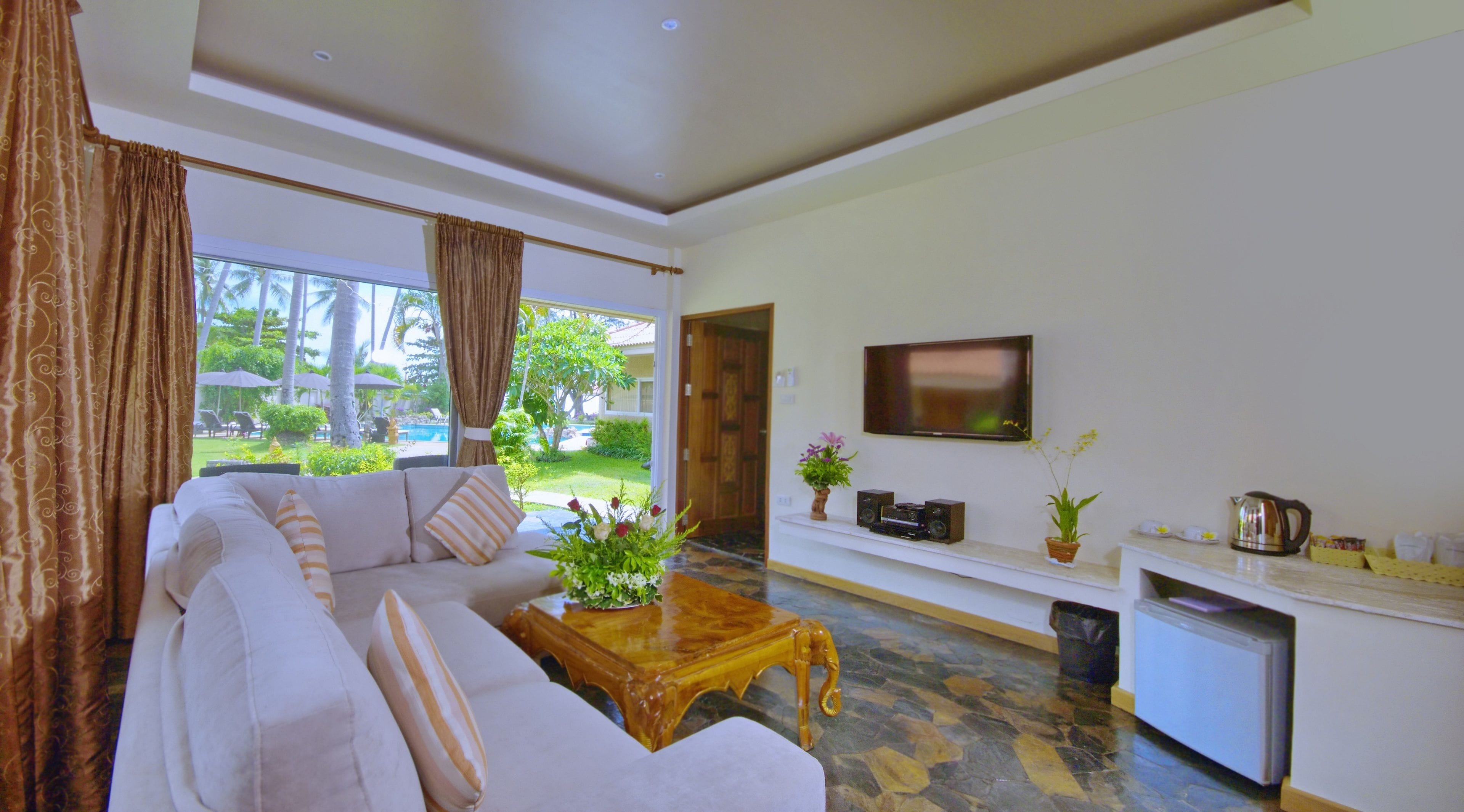 family garden view villa | living room | flat-screen tv, dvd player, books