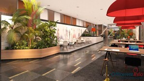 Un área de recepción moderna con un mostrador curvo, asientos y un mural grande en la pared.