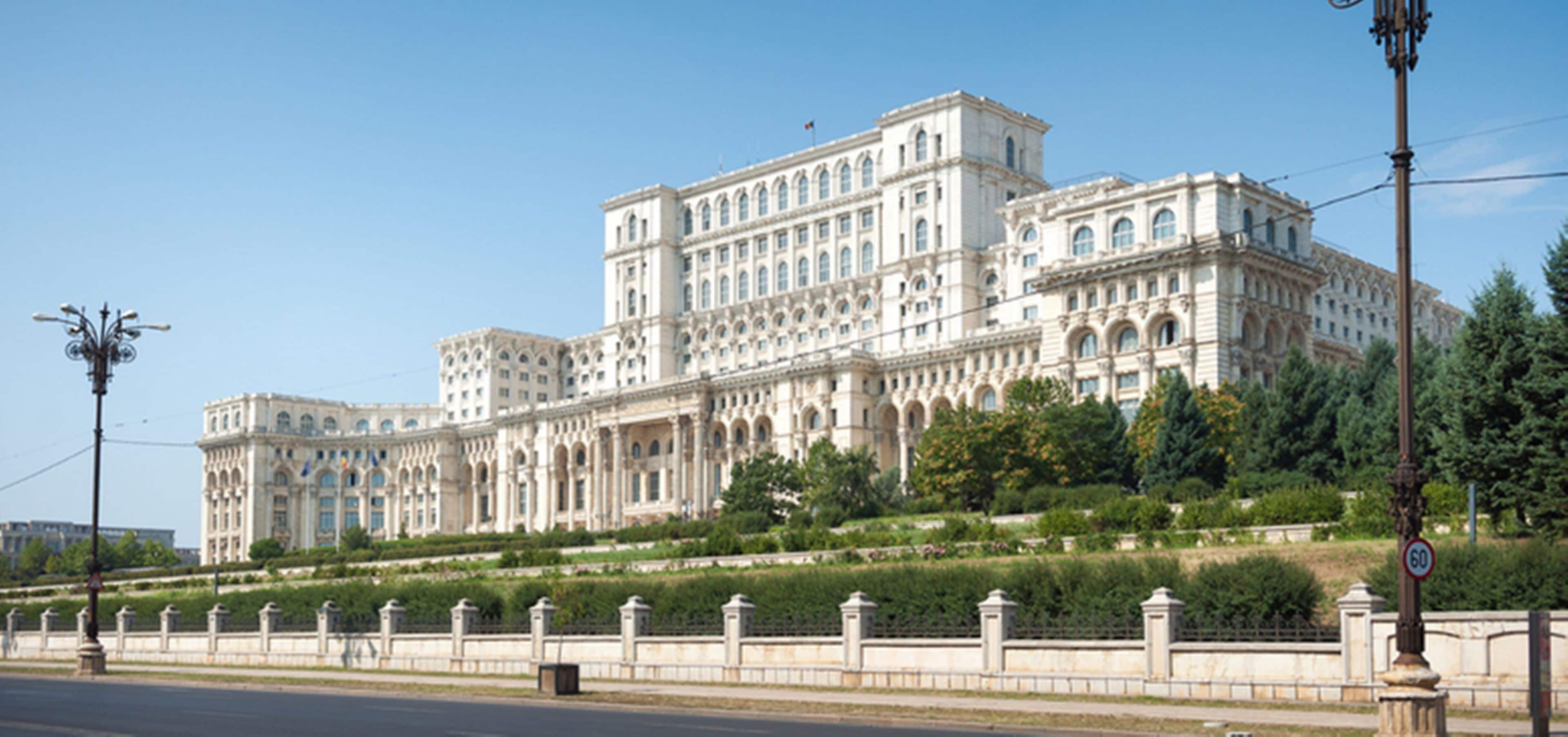 A large, historic building with multiple wings and a central courtyard.