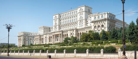 A large, historic building with multiple wings and a central courtyard.