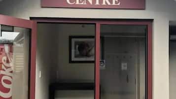 A building with a sign reading "Conference Centre" above a glass door.