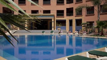 Relax by the rectangular pool surrounded by lounge chairs and take in the views of the surrounding architecture.