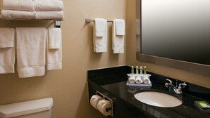 A bathroom with a toilet, sink, and towels on a rack. - Holiday Inn Express & Suites Chicago West-Roselle by IHG (Roselle)