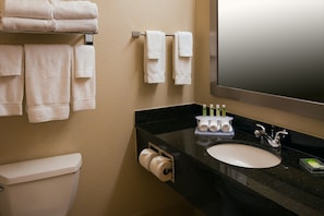 A bathroom with a toilet, sink, and towels on a rack. - Holiday Inn Express & Suites Chicago West-Roselle by IHG (Roselle)