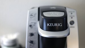 A close-up of a coffee maker with the brand name "KEURIG" on it. - Holiday Inn Express & Suites Chicago West-Roselle by IHG (Roselle)