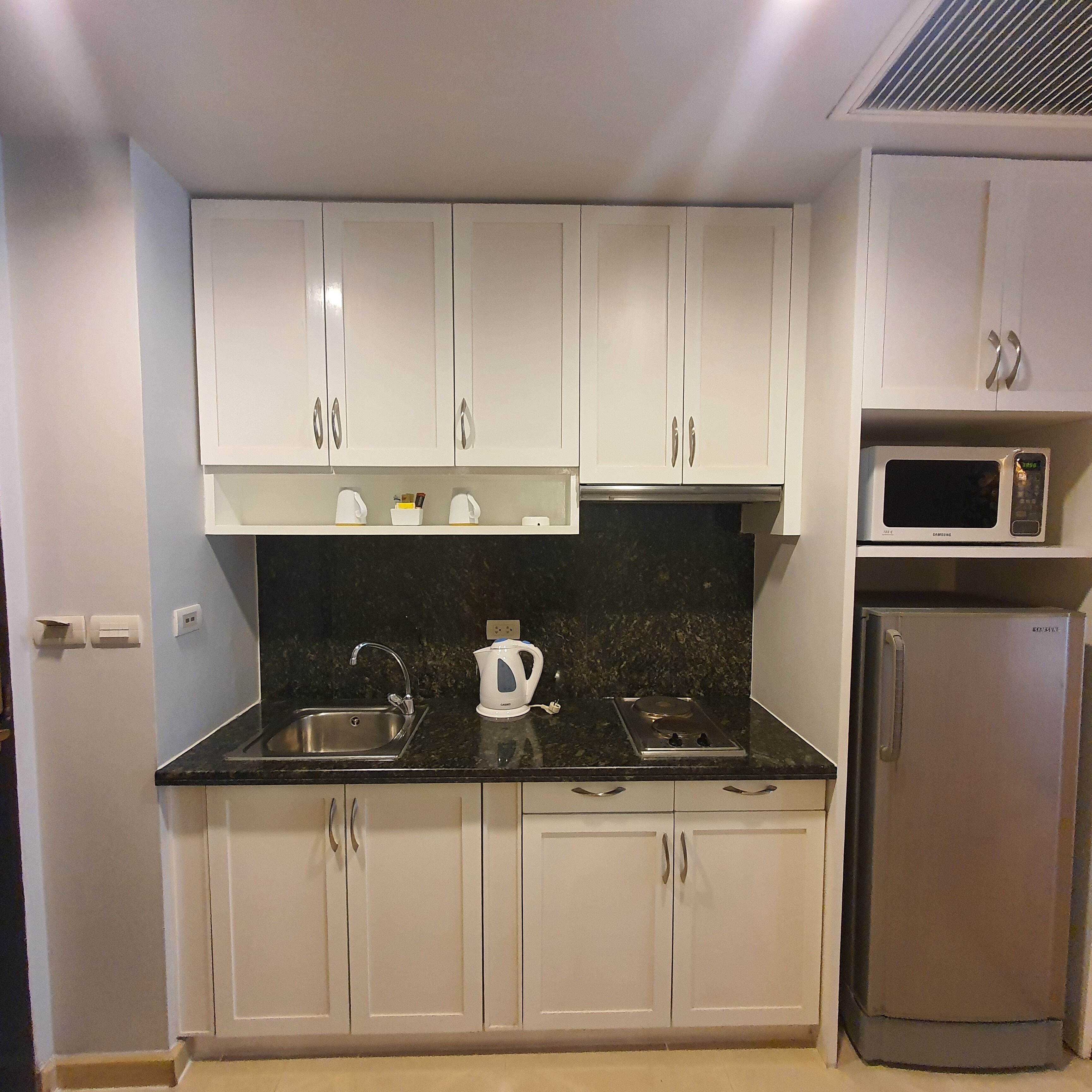 premier studio, 1 king bed with balcony | private kitchen | fridge, microwave, coffee/tea maker, electric kettle