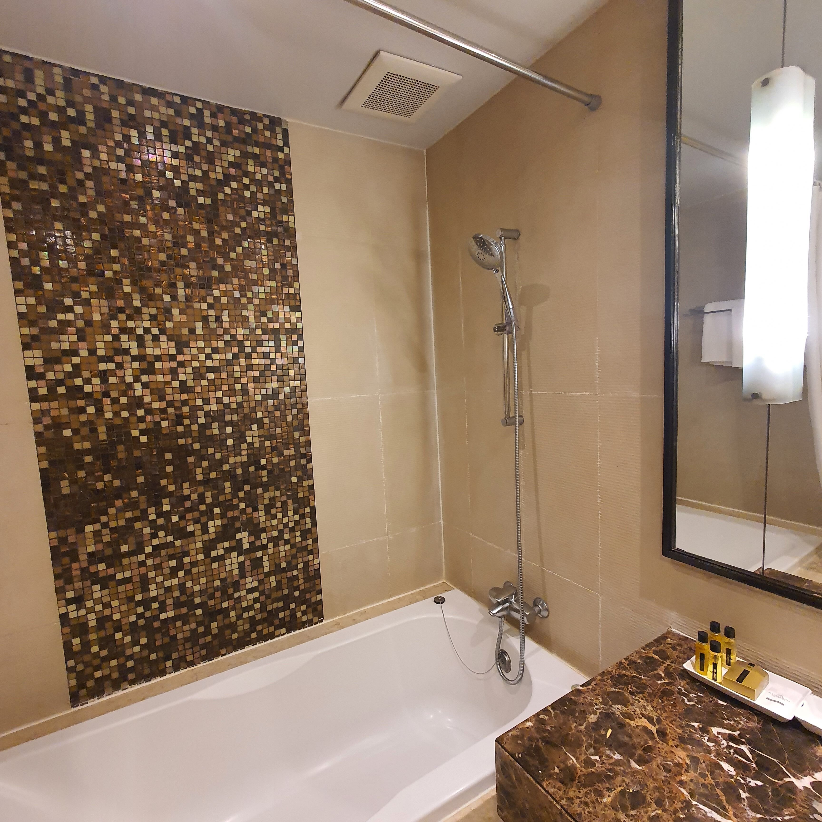 premier studio, 1 king bed with balcony | bathroom | combined shower/bathtub, deep-soaking bathtub, free toiletries