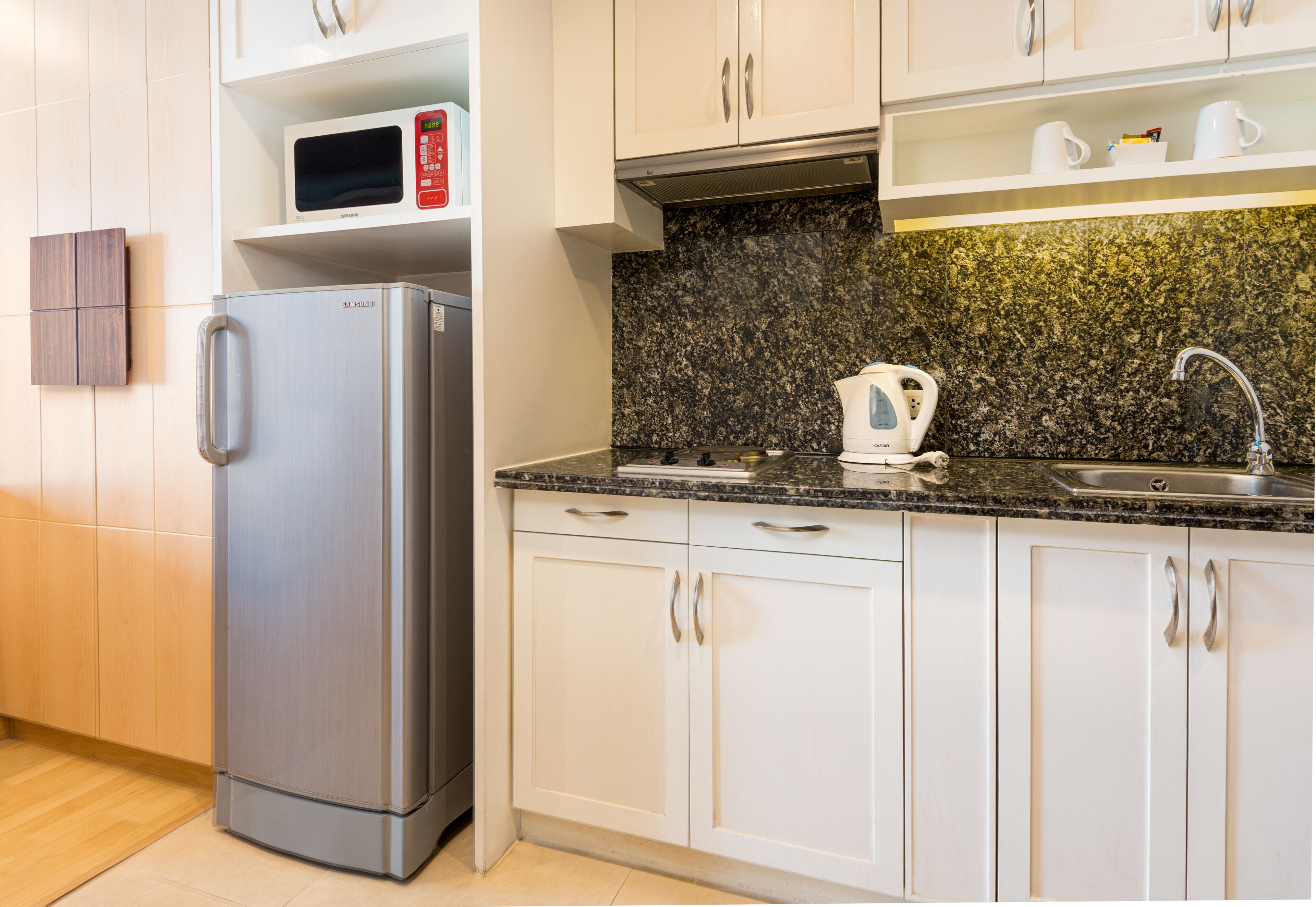 premier studio, 1 king bed with balcony | private kitchen | fridge, microwave, coffee/tea maker, electric kettle