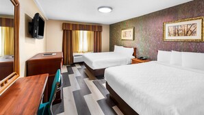 A hotel room with two beds, a desk, a chair, a television, and artwork on the walls. - Rodeway Inn Capri (Little Ferry)