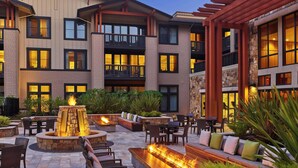 A multi-story hotel with outdoor seating areas featuring fire pits and comfortable seating. - The Westin Verasa Napa (Napa)