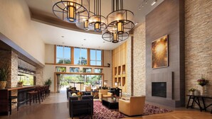 A spacious lobby with a fireplace, seating area, and a bar. - The Westin Verasa Napa (Napa)