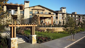 A multi-story hotel with a stone facade, a covered entrance, and a landscaped garden. - The Westin Verasa Napa (Napa)
