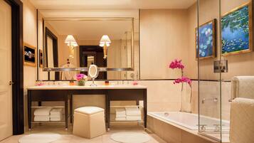 A modern bathroom with a large mirror, two sinks, a bathtub, and a glass shower enclosure.