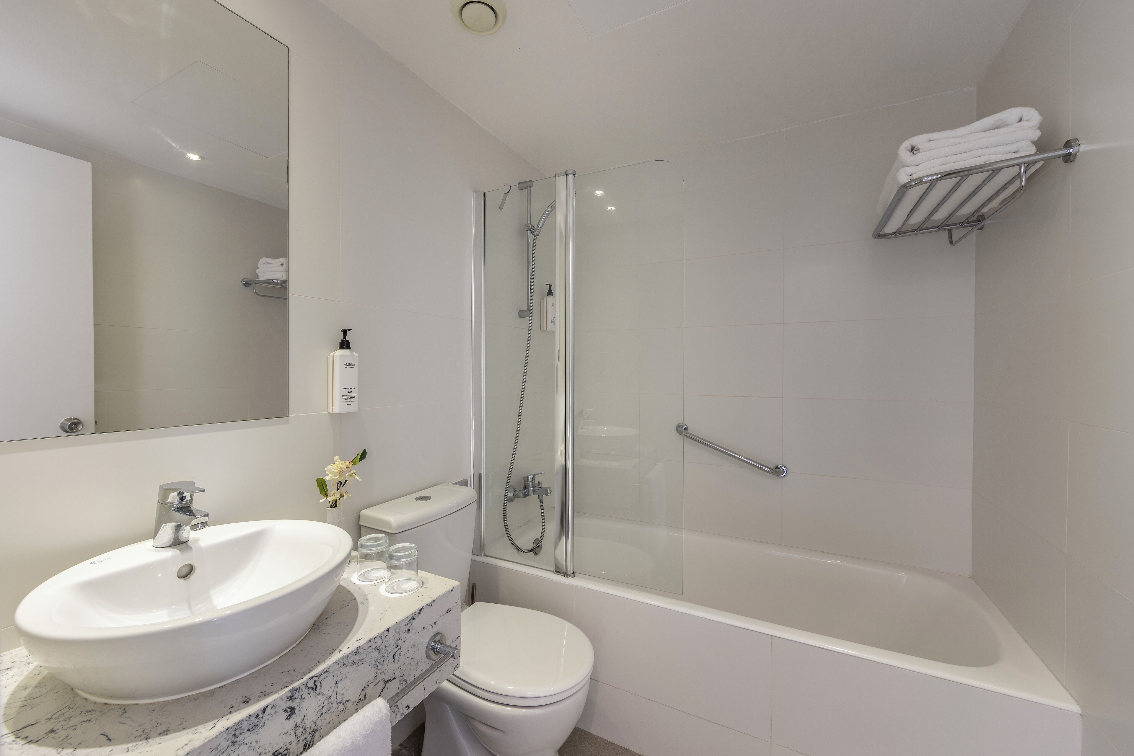 bathtub, rainfall showerhead, towels