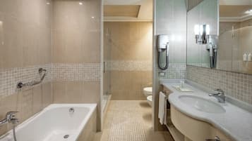 A modern bathroom with a bathtub, a shower, and a sink.