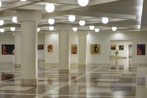 A spacious gallery with high ceilings and modern lighting.