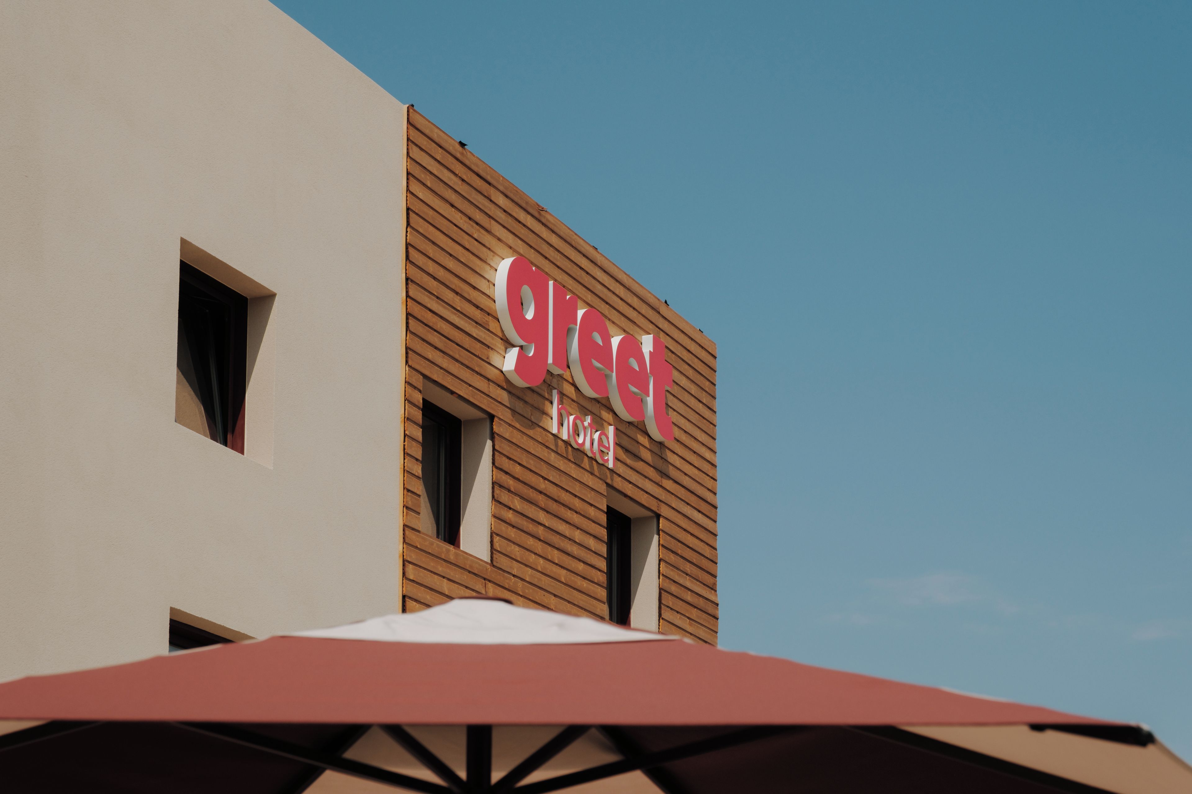 A hotel sign with the name 'GREAT HOTEL' on a building facade.