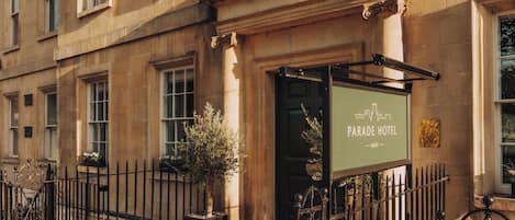 A building with a sign reading 'Parade Hotel Bath.'