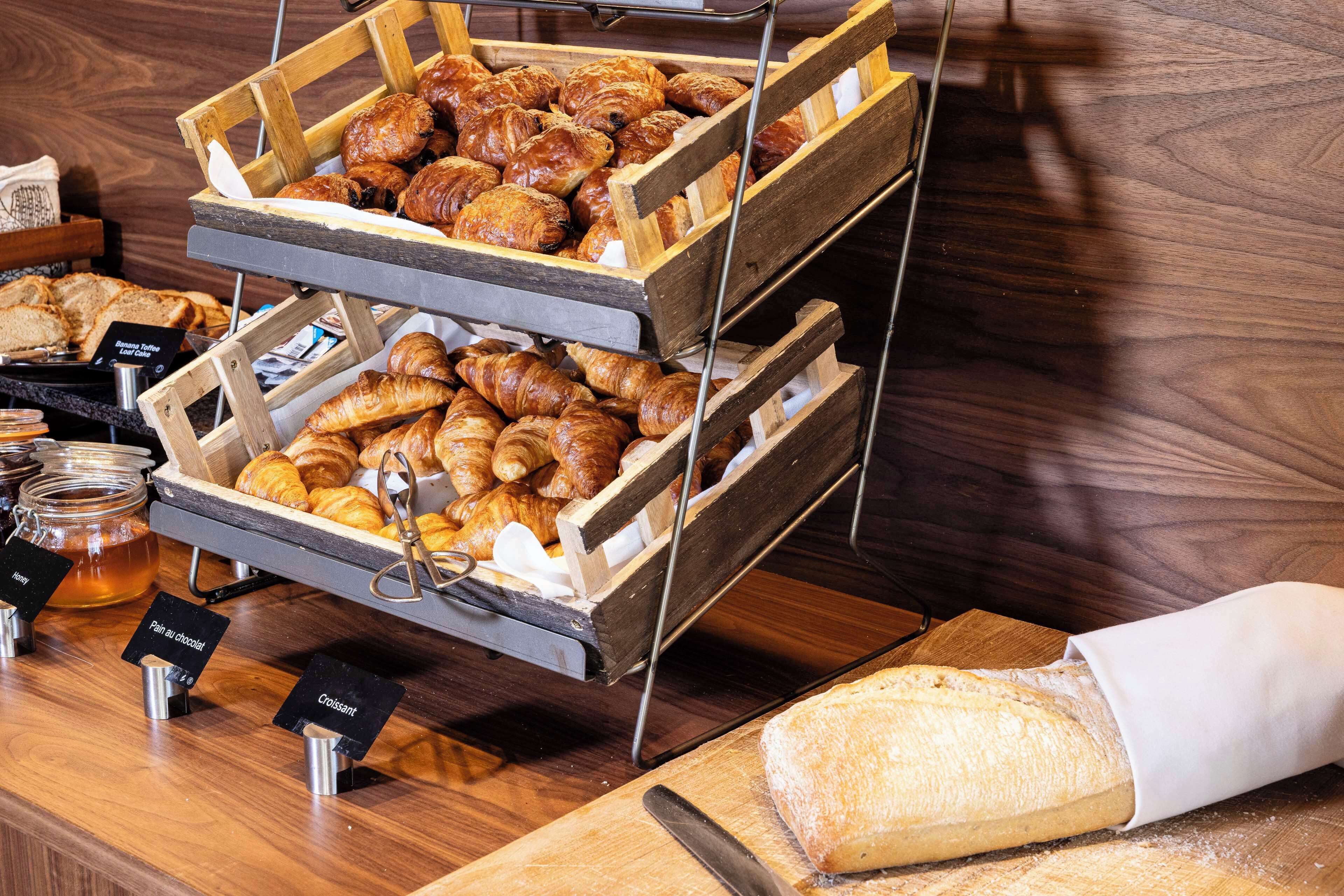 A bakery display with various pastries and bread.