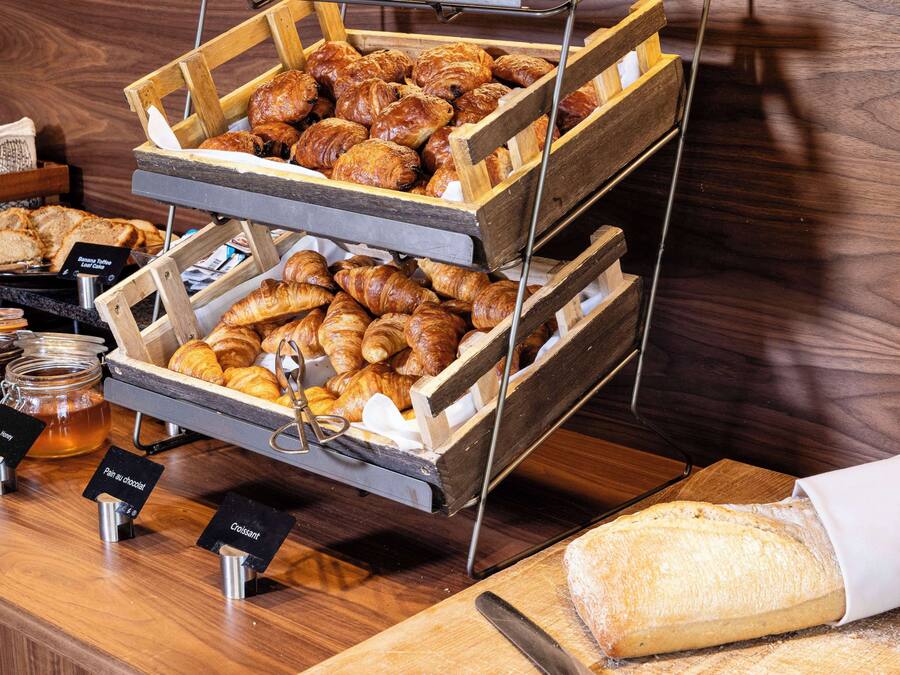 A bakery display with various pastries and bread.