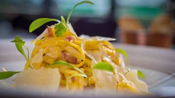 A close-up of a pasta dish with garnishes.