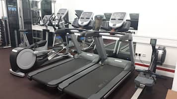 A gym with multiple treadmills and exercise equipment.